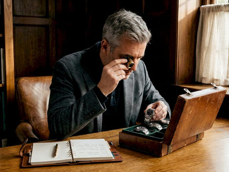 Collector reviewing watches in home study
