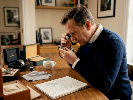 Collector examining luxury watch at home table