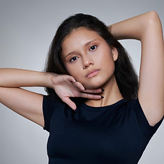 Female model in blck tight fitted clothes on gray backdrop at LPS Headshot Studio Bangkok