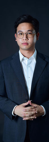 Male office manager in dark business suit on black backdrop at LPS Headshot Studio Bangkok