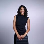 Female manager in black dress on steel colored backdrop at LPS Headshot Studio