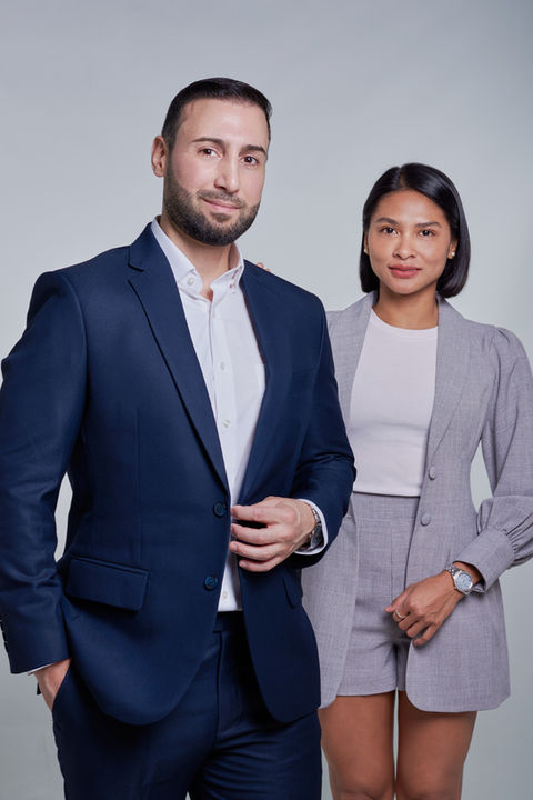 Male executive in blue business suite and female manager in gray suite on gray backdrop at LPS Headshot Studio central Bangkok