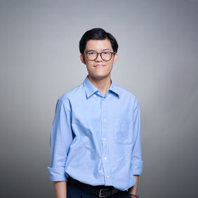 Male it professional in blue smart casual lookon gray backdrop at LPS Headshot Studio central Bangkok
