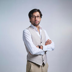 Male professional in white vest on white backdrop at LPS Headshot Studio