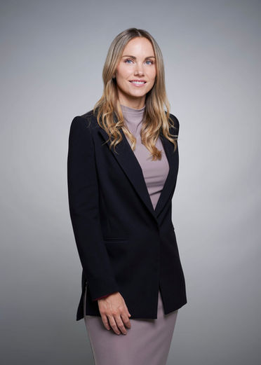 Female manager in dark jacket on gray backdrop at LPS Headshot Studio