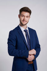 Male professional in blue suite on off white backdrop at LPS Headshot Studio