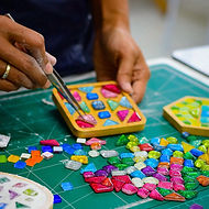 Students arranging mosaic tiles during a Mosaic Art Workshop at GIGIPAYNE Studio in Bangkok.