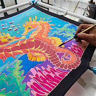 Students applying wax and colors to fabric during a Batik Textile Workshop at GIGIPAYNE Studio in Bangkok.