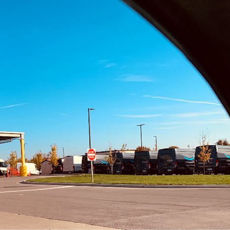 Amazon Warehouse Facility with delivery trucks and blue skies.