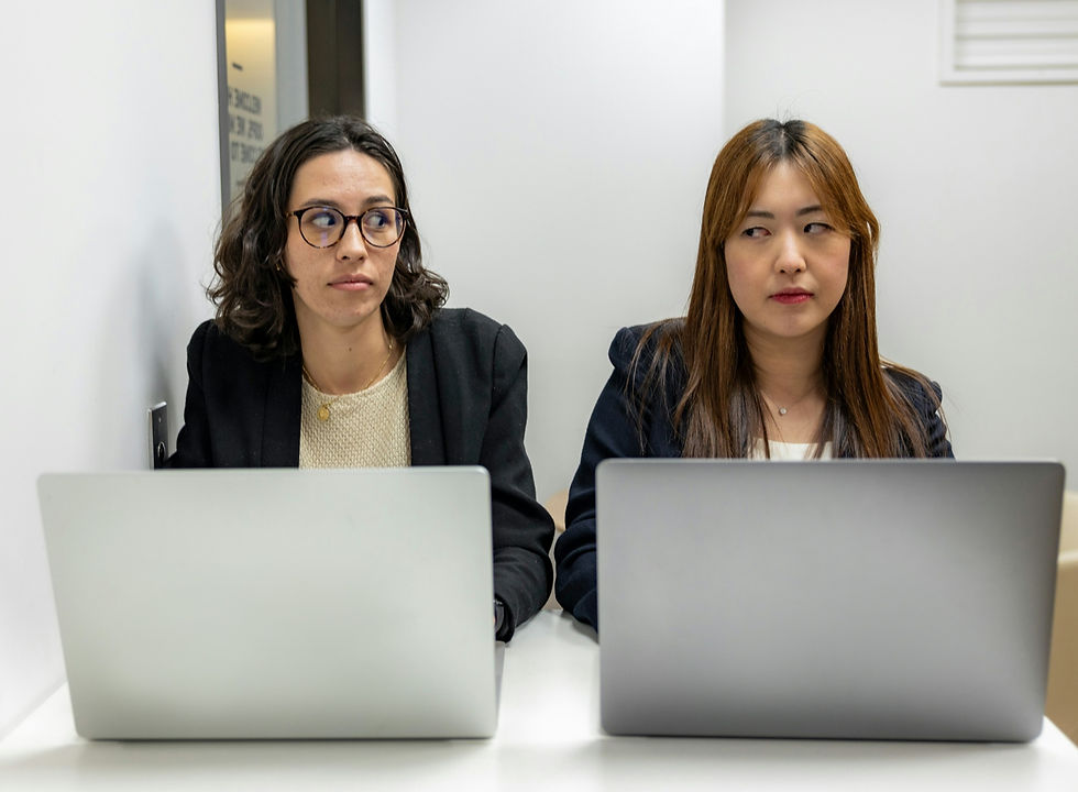 Two office workers looking suspicious