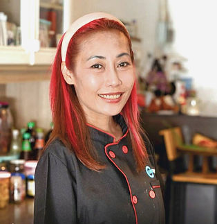 Smiling chef Apple with red hair in black uniform