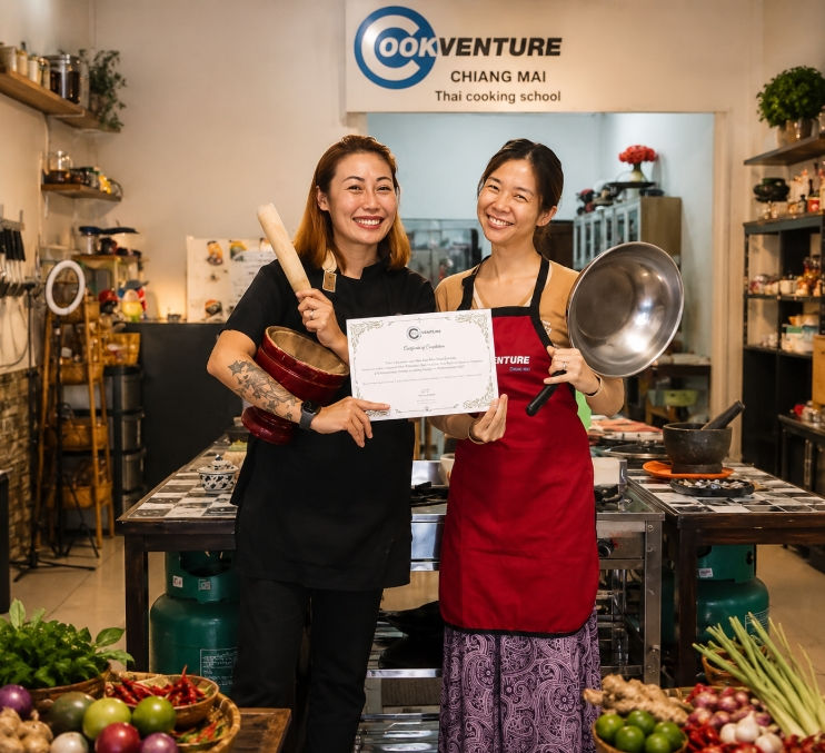Student receiving a certified culinary certificate at Cookventure Home Cooking Studio for the Thai DTV visa application.