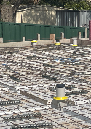 Building foundation with rebar and bedbug prevention risers