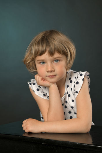 Natürliches Kinderporträt eines Mädchens im gepunkteten Kleid im Fotostudio Wiener Neustadt