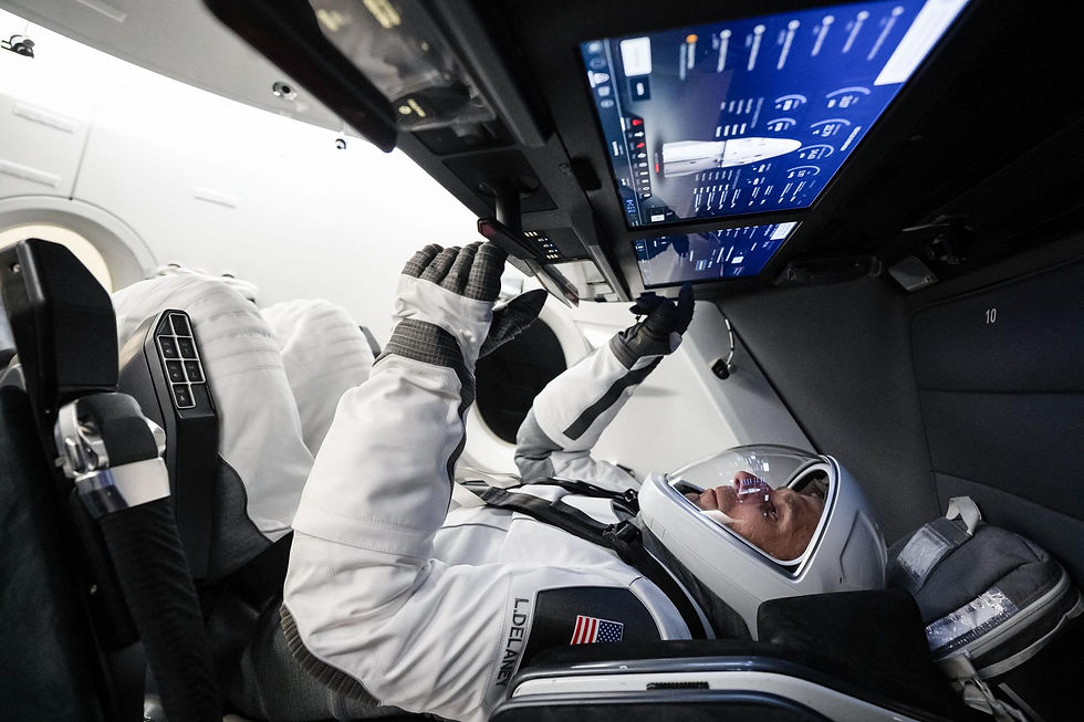 NASA astronaut and SpaceX Crew‑13 Pilot Luke Delaney sits inside a Dragon spacecraft mockup while tapping a cockpit screen interface during a pre‑flight training session at SpaceX headquarters in Hawthorne, California. Image Credit: SpaceX