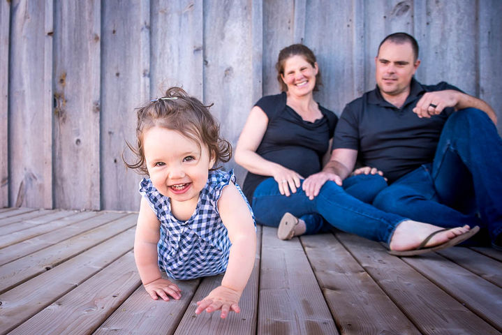 Family photographer captures a beautiful toddler crawling towards the camera in Lucknow, Ontario.