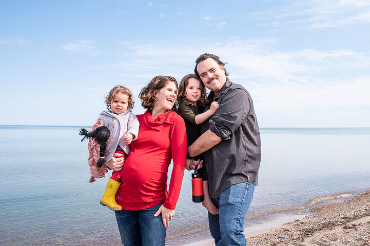 Fun couple pose for photos on the beach in Point Clark