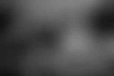 Mother comforts her crying daughter while also holding infant son during a documentary family photoshoot in Kincardine