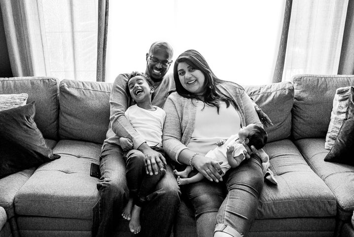 Toddler and newborn with parents smile for camera during Port Elgin Newborn Photos
