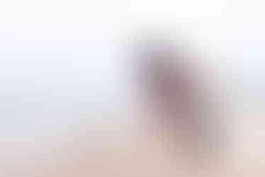 Man skips stones on a Kincardine Beach during an extended family photoshoot