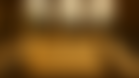 Ancient scroll with Greek text on a pedestal in a sunny stone pavilion with arched openings. Mountains visible in the background.