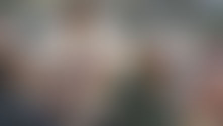 A man in robes teaches a group of attentive people near a riverbank. The scene is calm, with earthy tones and soft lighting.