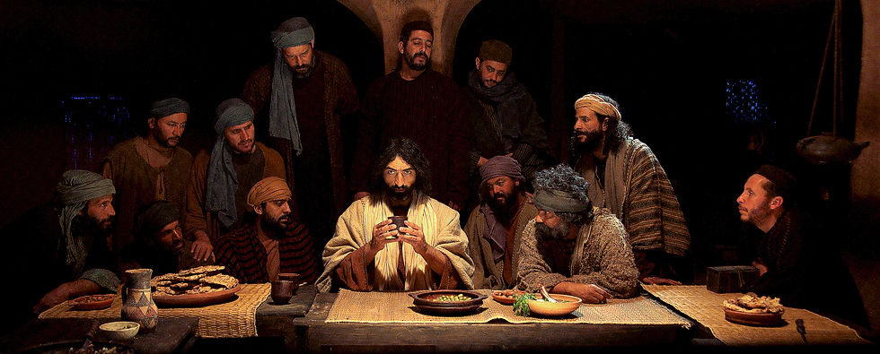 A group of men in robes gathered around a table with food and drink, one in white holding a cup. The setting is dim with a solemn mood.