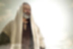 Bearded man in a beige robe gazes contemplatively at a bright sky. Soft clouds surround him, creating a serene and reflective mood.