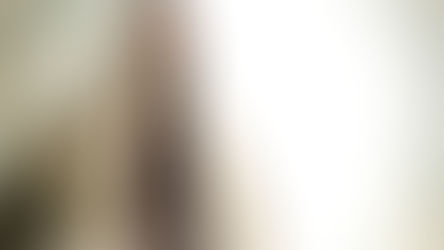 Bearded man in a beige robe gazes contemplatively at a bright sky. Soft clouds surround him, creating a serene and reflective mood.