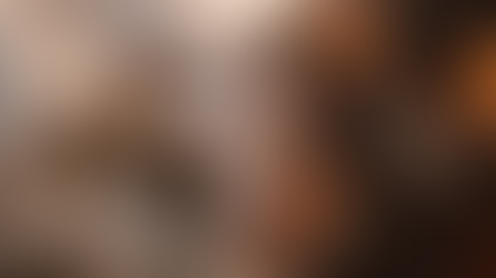 Angel and demon battle fiercely with swords and shields on a rocky landscape; bright light shines from above, contrasting fire and smoke.