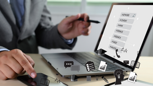 Google Helpful Content Update - A business person in a suit using their laptop and phone to research hashtags and strategizing for search engine results