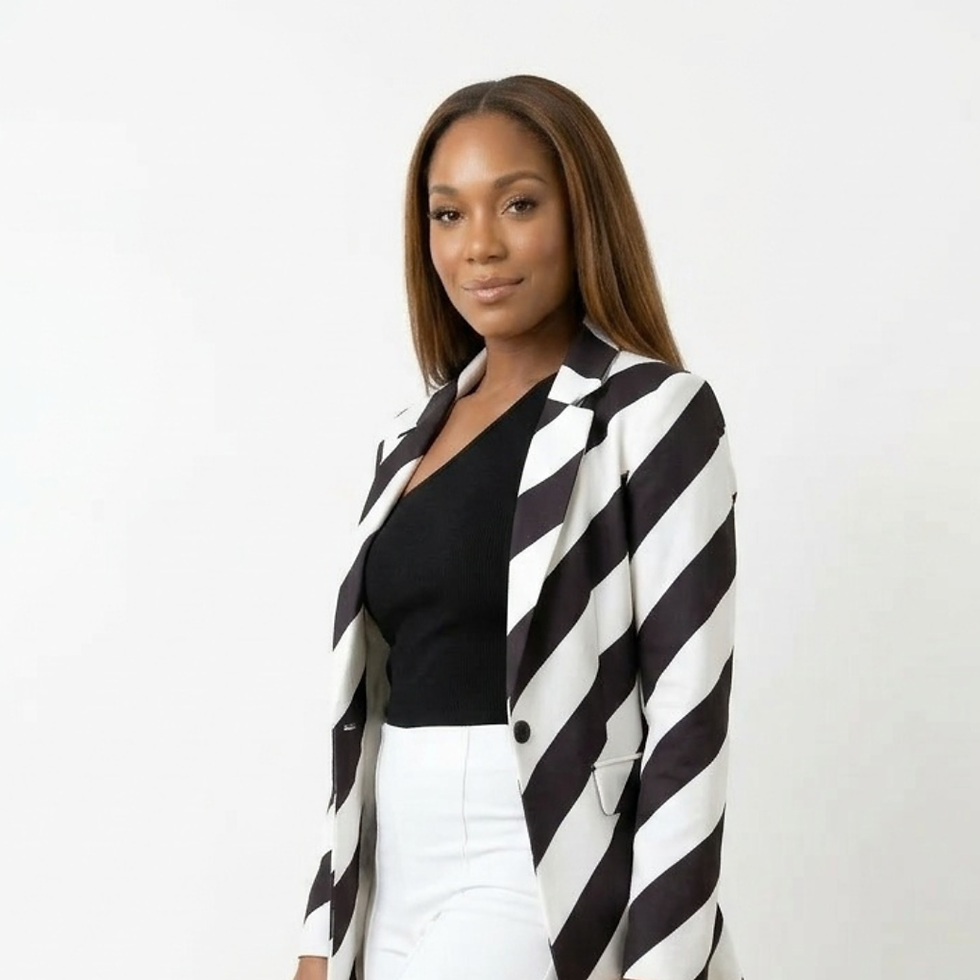 Eye-level view of a woman wearing a bold striped blazer paired with neutral trousers