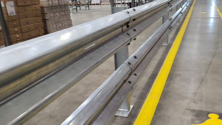 “Warehouse laid out next to the motorway—Guardian crash barriers lining the perimeter.”