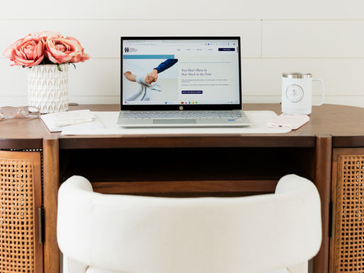woman on a computer with a blue long sleeve sweater