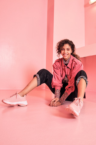 Model posing in front of pink background