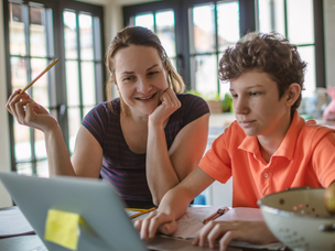 Mother helping son with schoolwork