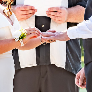 Close-up of a couple exchanging rings during a wedding ceremony at Butterfly Kisses Pavilion in Eastern North Carolina