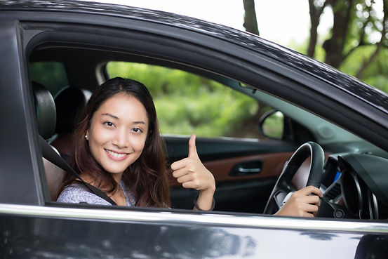 beautiful-asian-woman-smiling-and-enjoying-driving-a-car-on-road-for-travel-free-photo.jpg