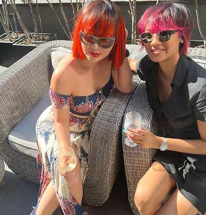 two women with glossy and bright Coloured hair.