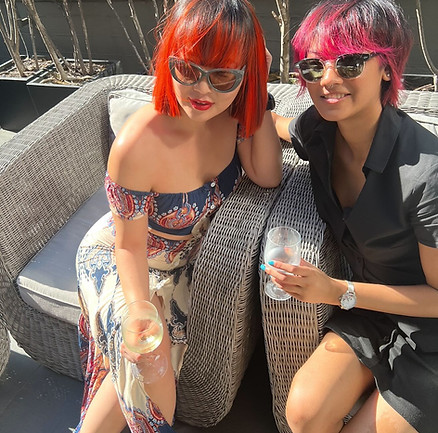 two women with glossy and bright Coloured hair.