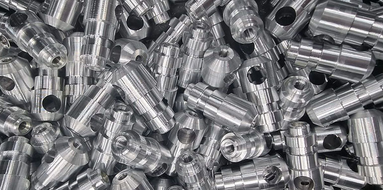Batch of custom-machined aluminum components featuring detailed turning and drilling for precision applications