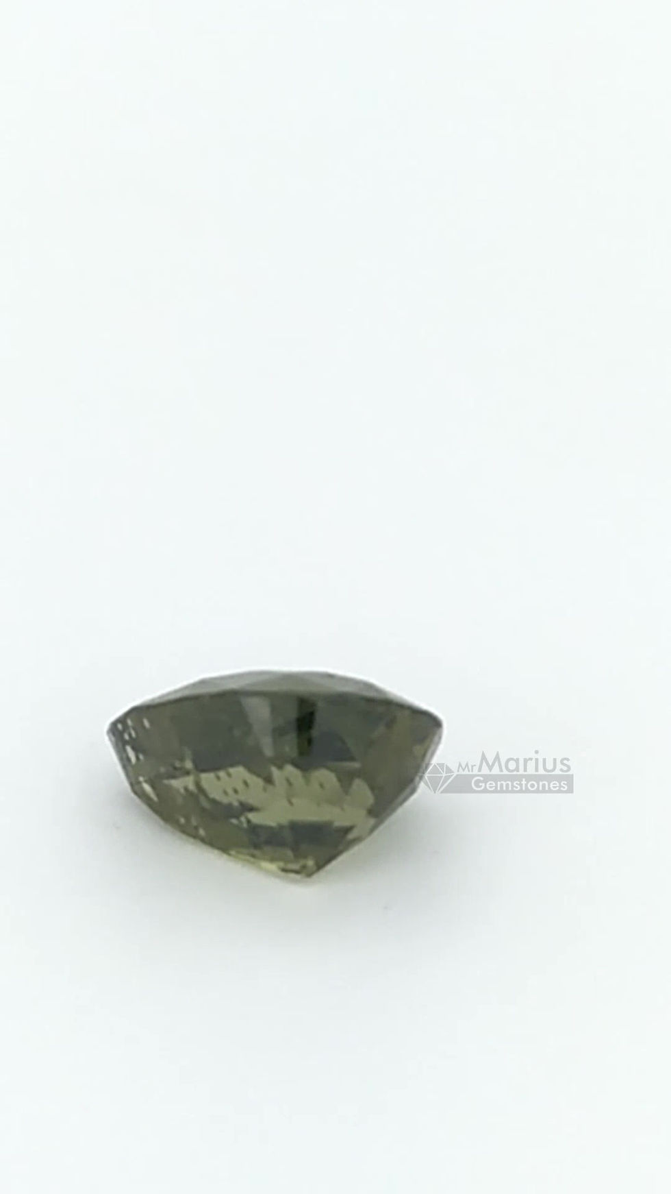 Thumbnail: Greenish yellow zircon, pear shaped with some inclusions.