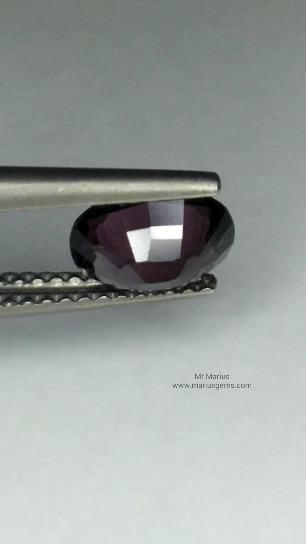 Thumbnail: Dark purple spinel, oval cut.