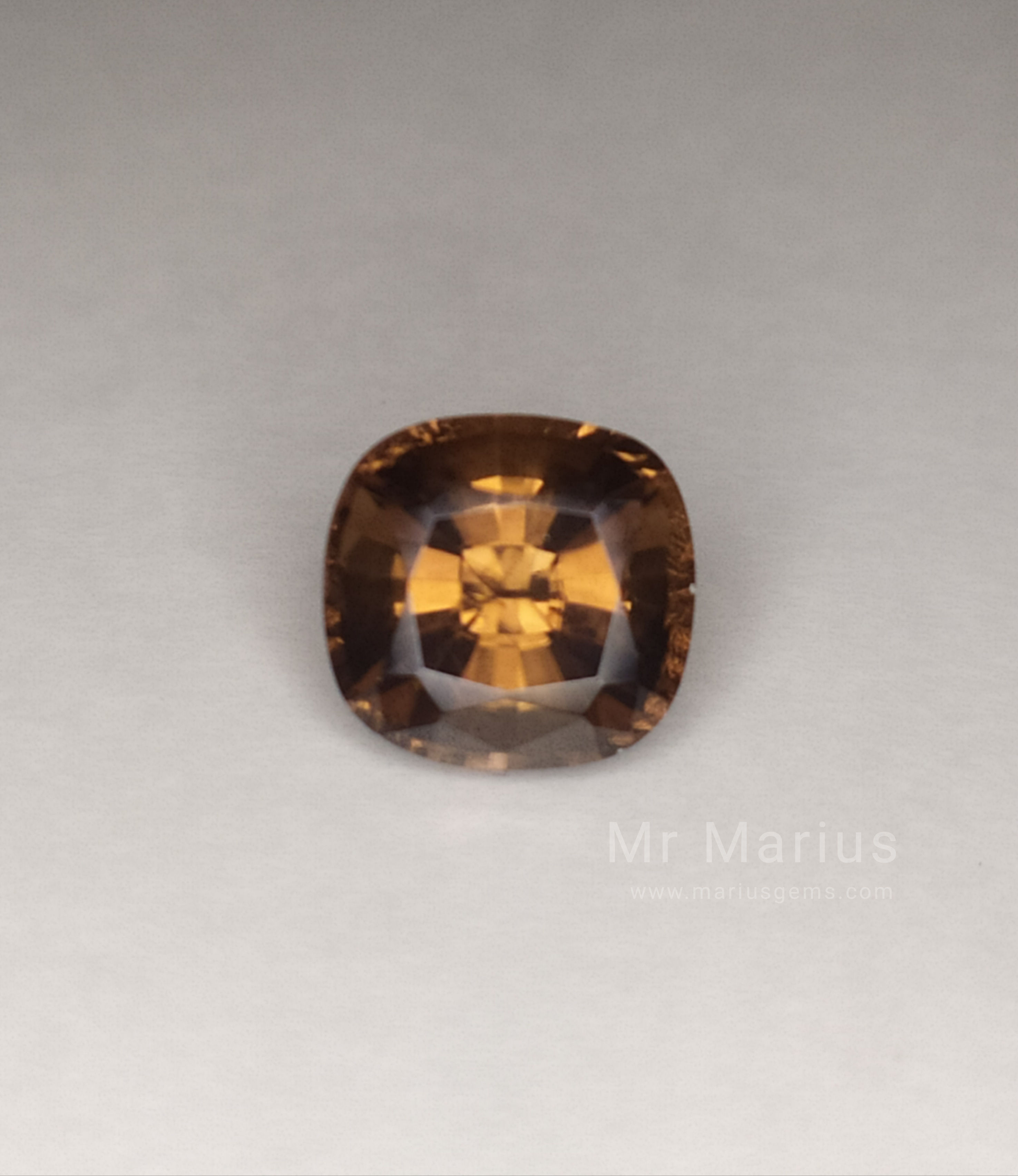 Brown zircon cushion cut, good brilliance. front view.