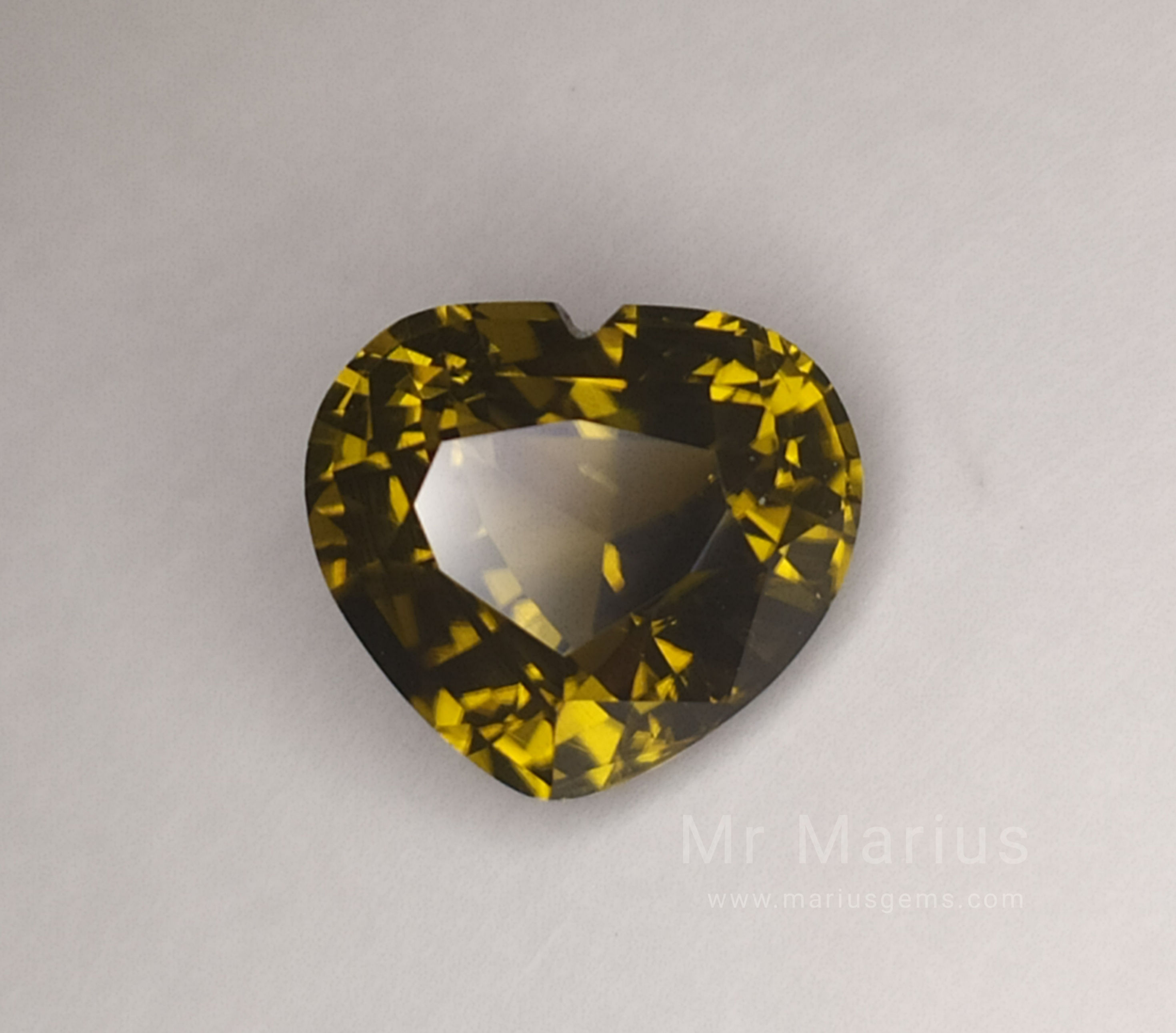 A heartshaped zircon with a brownish green colour.