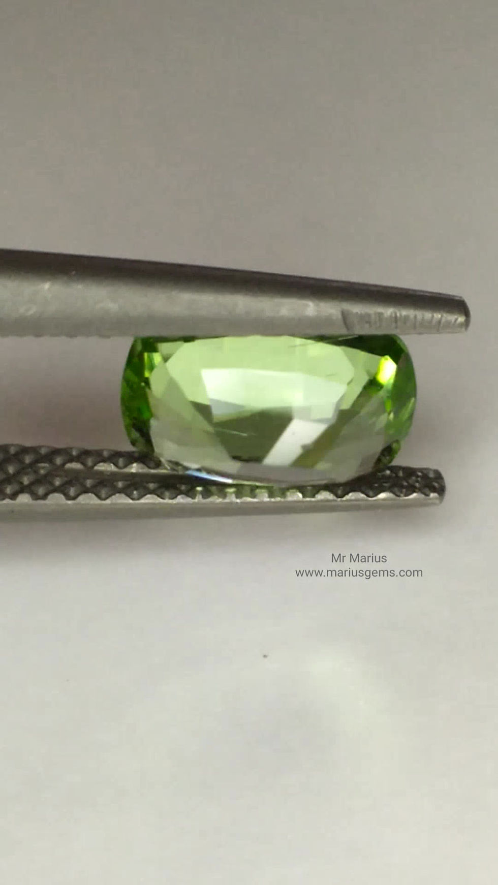Thumbnail: Bright light green cushion cut rare norwegian peridot. Front view.