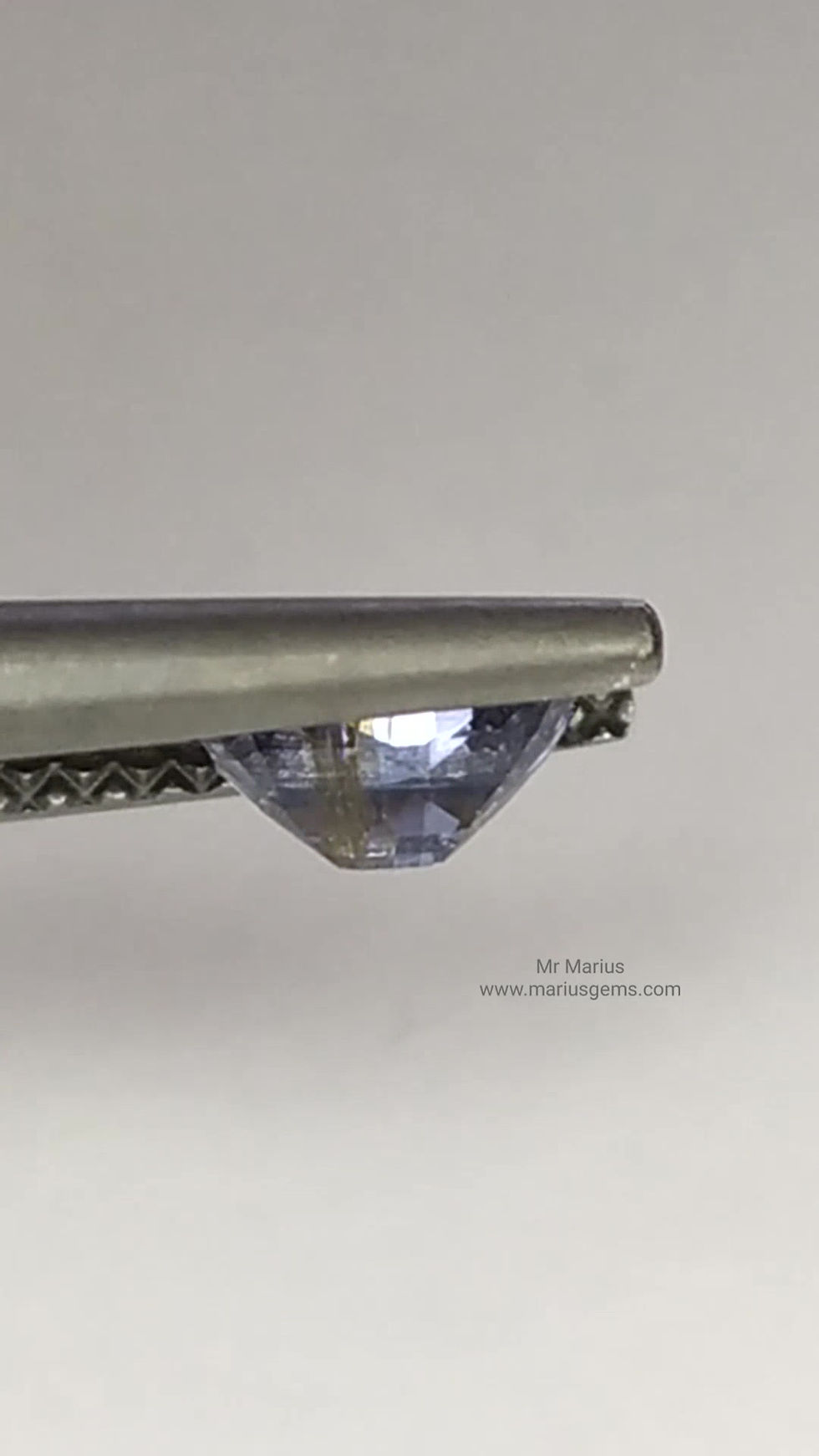 Thumbnail: Light blue spinel with a brown inclusion. Cushion cut.