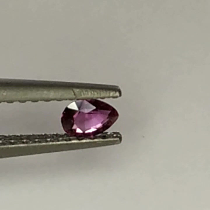Small unheated redish purple sapphire, pears shaped cut.