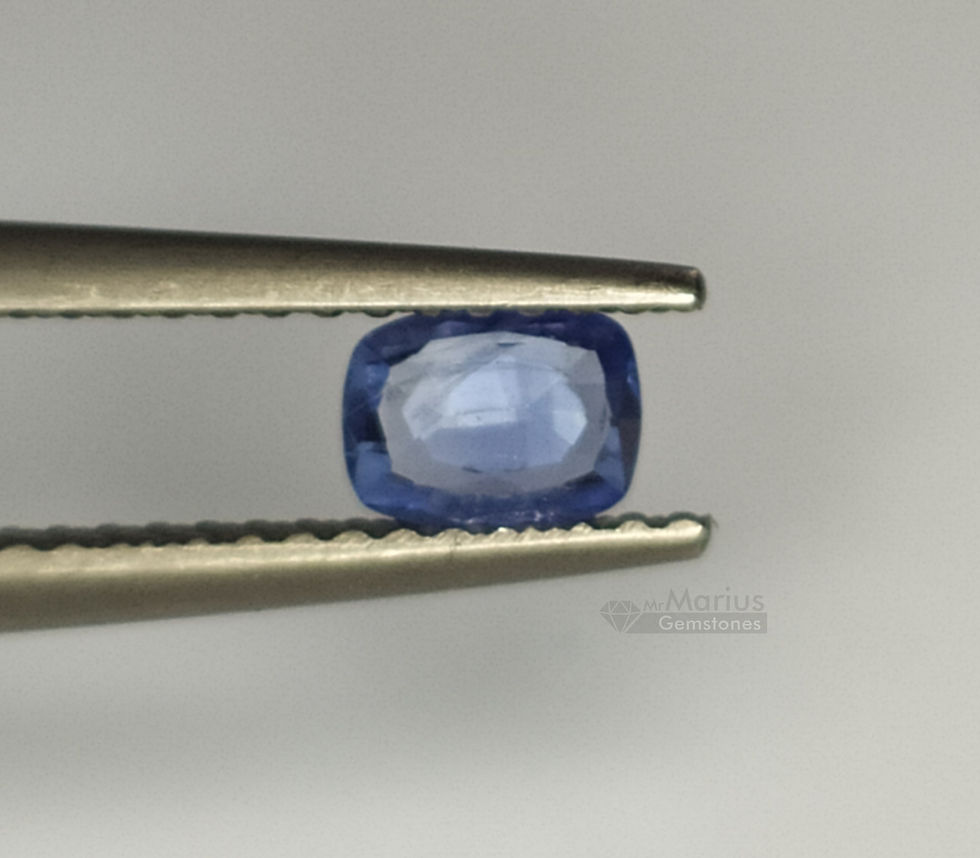 Unheated blue sapphire with some inclusions and an uneven cut. Cheap. Pavillion side.