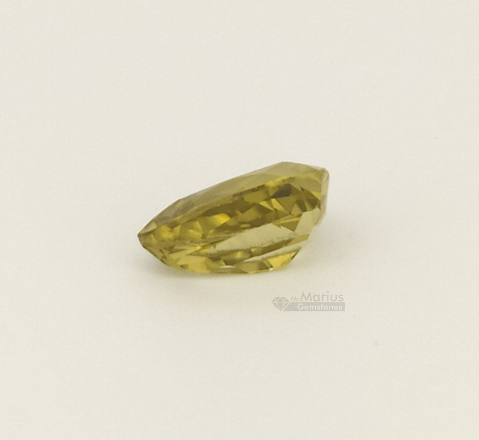Greenish yellow zircon. Trilliant cut. Side view.